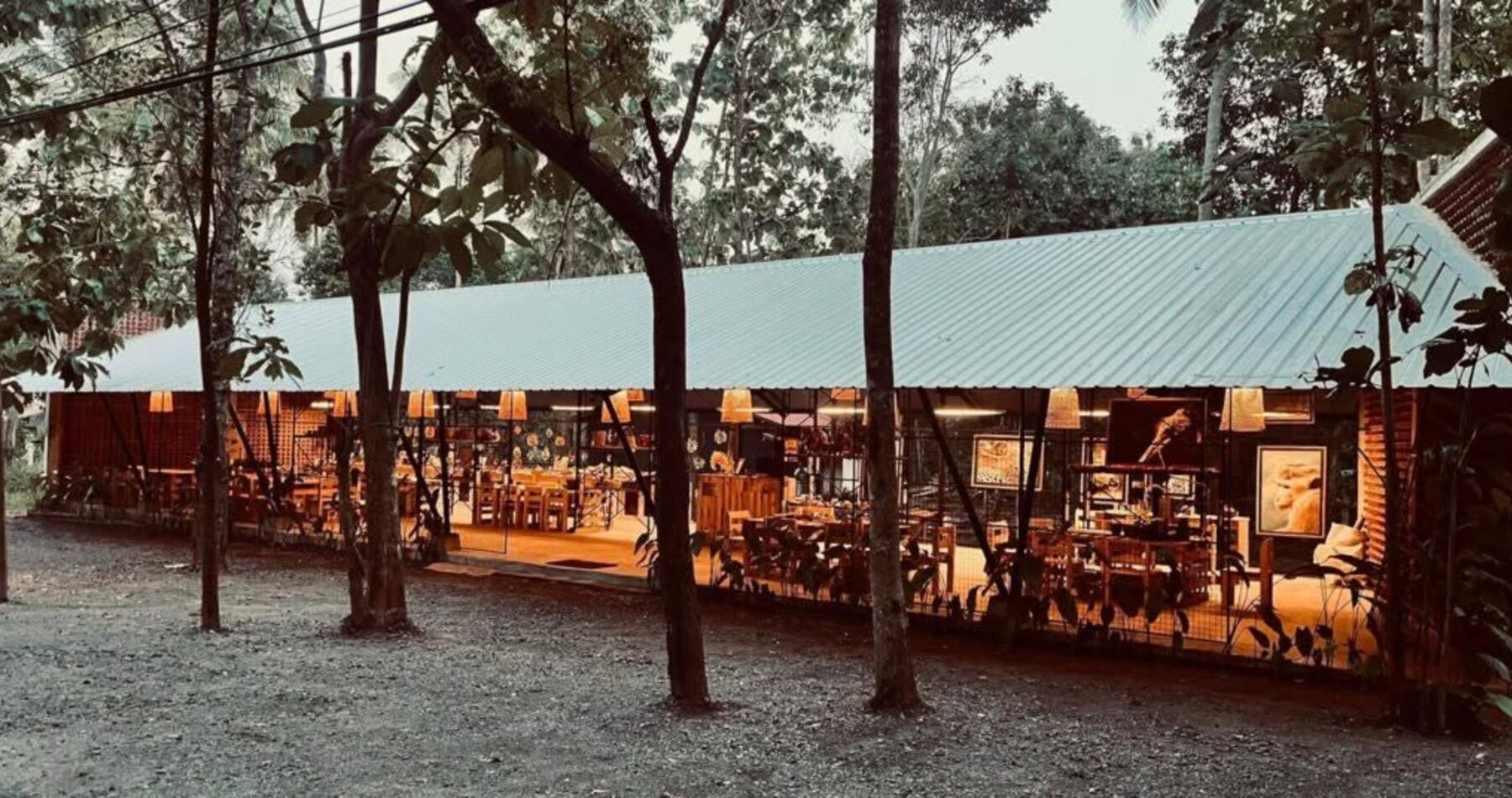 The ZeroPlastic Impact Center craft studio in Sigiriya at dusk, workbenches set up for hands-on craft sessions.