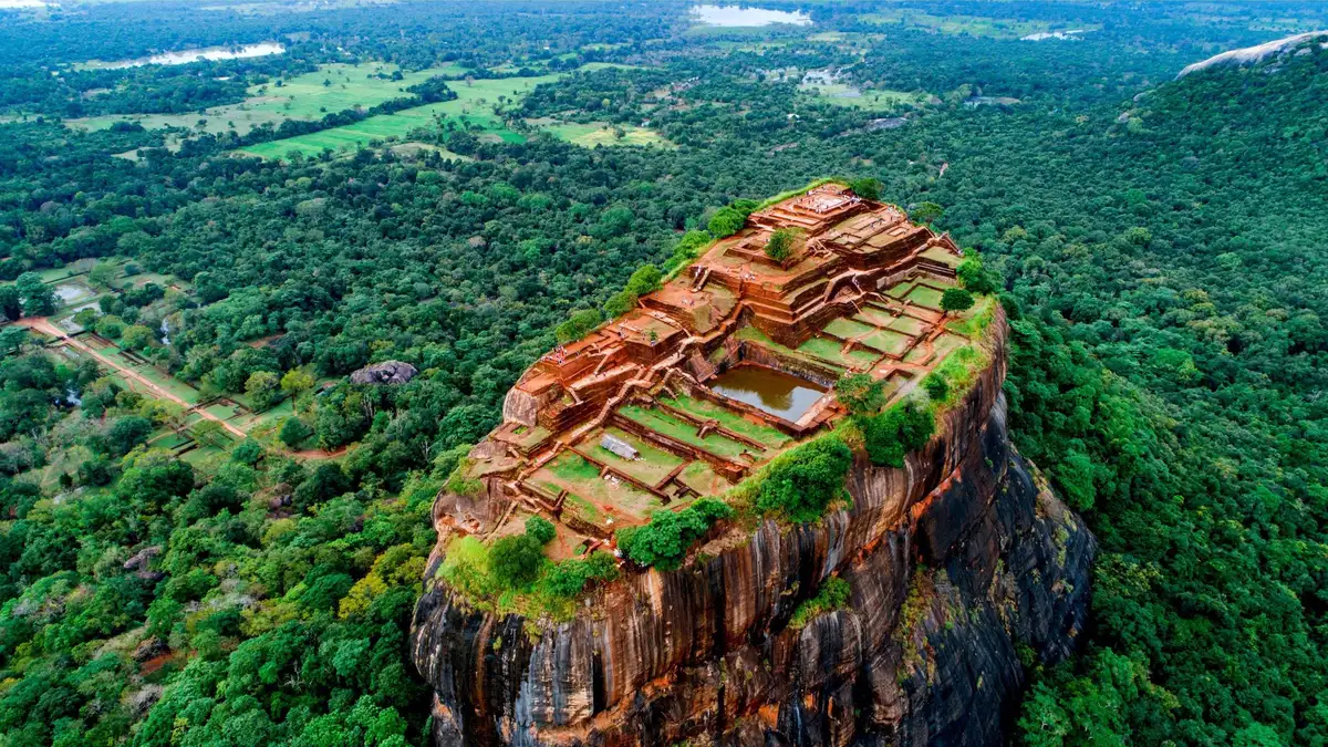 Sigiriya Lion Rock seen from the air, with the terraced gardens and the flat summit plateau.