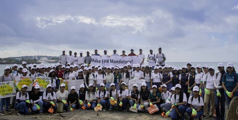 ZeroPlastic volunteers in cleaning gloves at a coastal clean-up in Sri Lanka, holding a banner reading Make EPR Mandatory.