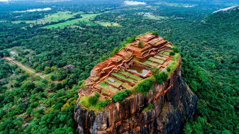 Aerial view of Sigiriya rock and the surrounding terraces and forest in central Sri Lanka.